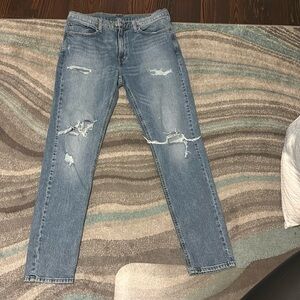 Worn, light blue distressed jeans, size 36/34